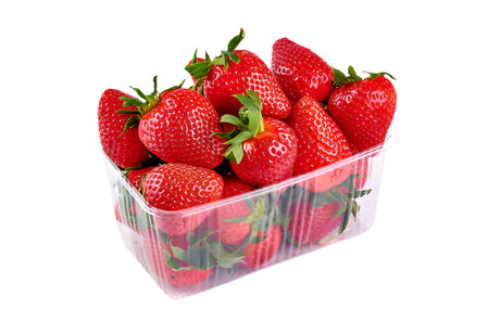 Clear plastic container filled with red strawberries on a white background